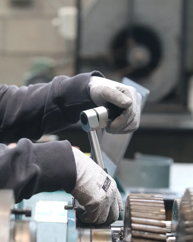 Maintenance mechanic torquing a fastener on industrial rotating equipment